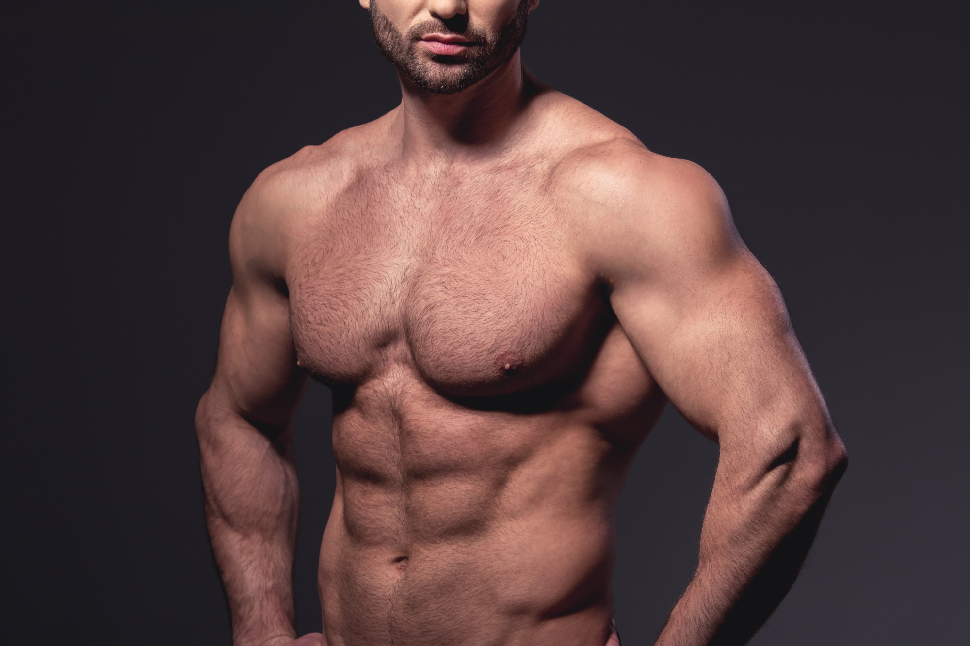 Picture of a musclebound six-pack man with his top off