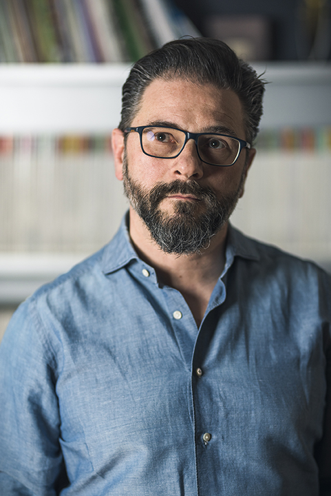 man with beard and glasses wearing blue shirt