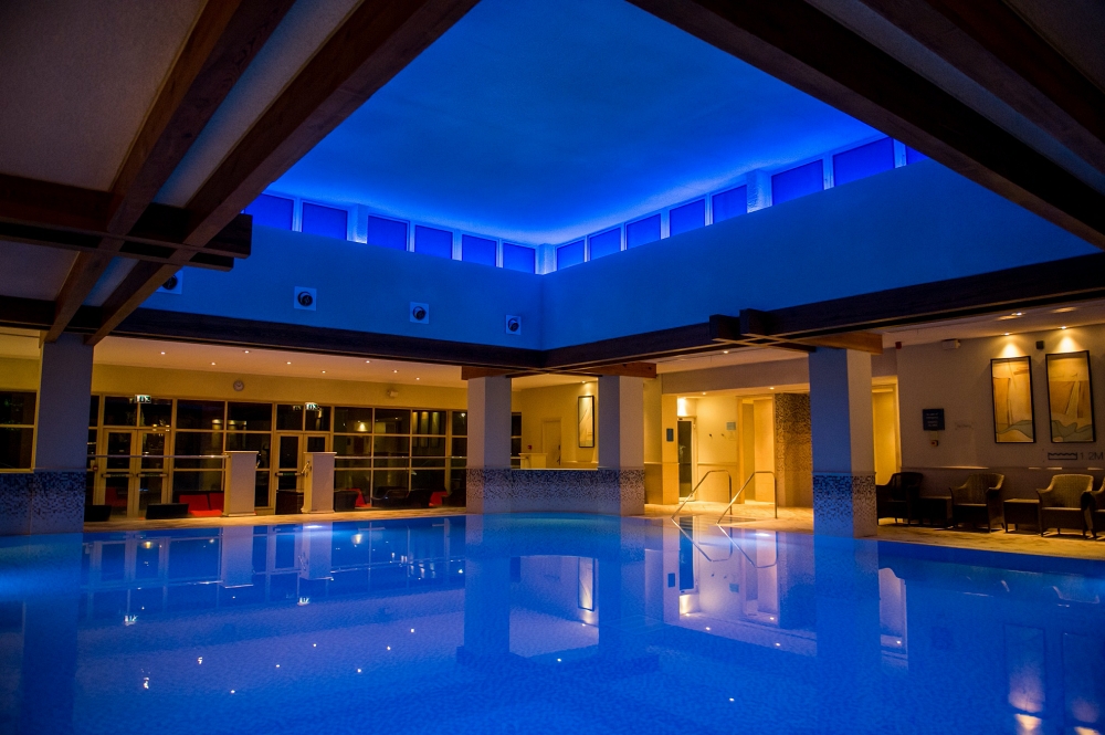 A swimming pool lit with blue light