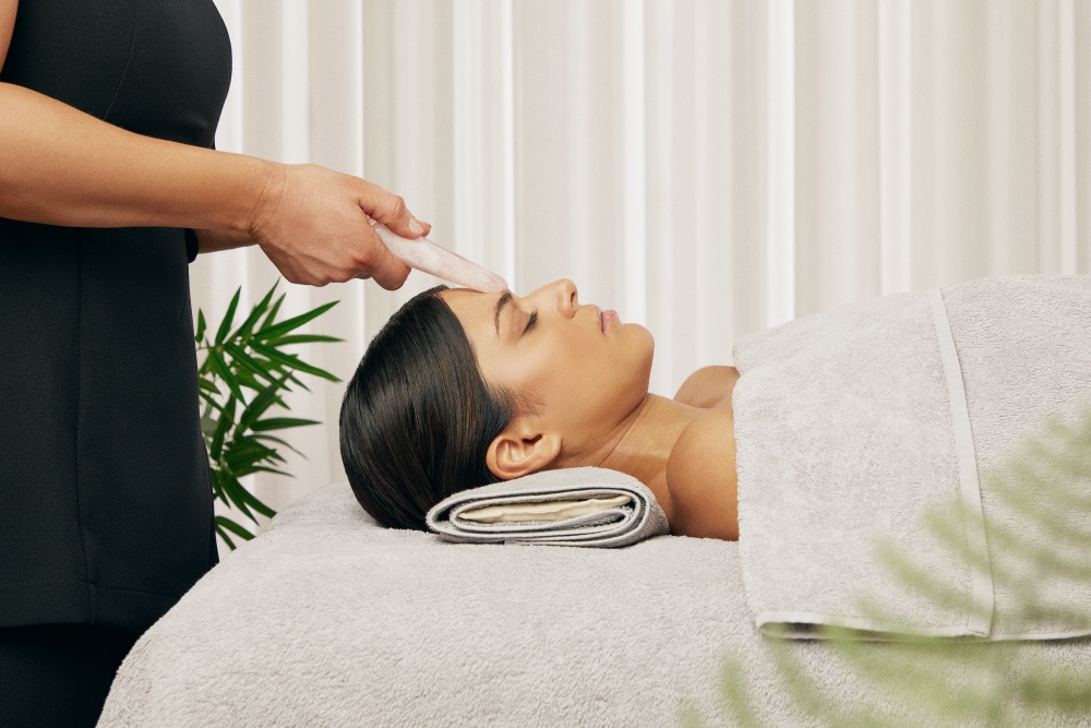 Woman receiving ESPA facial from spa therapist
