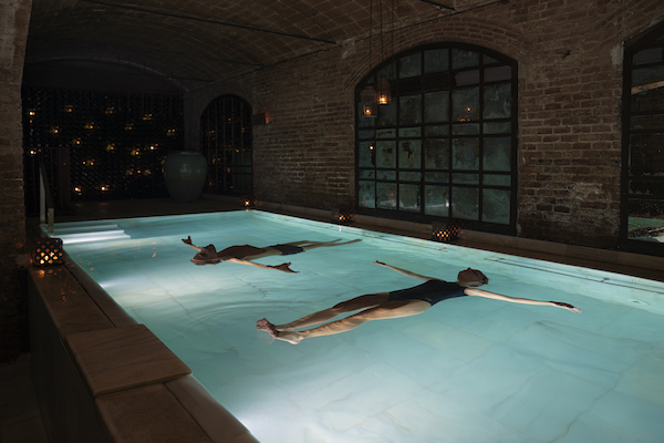 women floating in an indoor pool