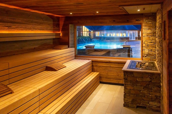 indoor sauna looking out to a swimming pool