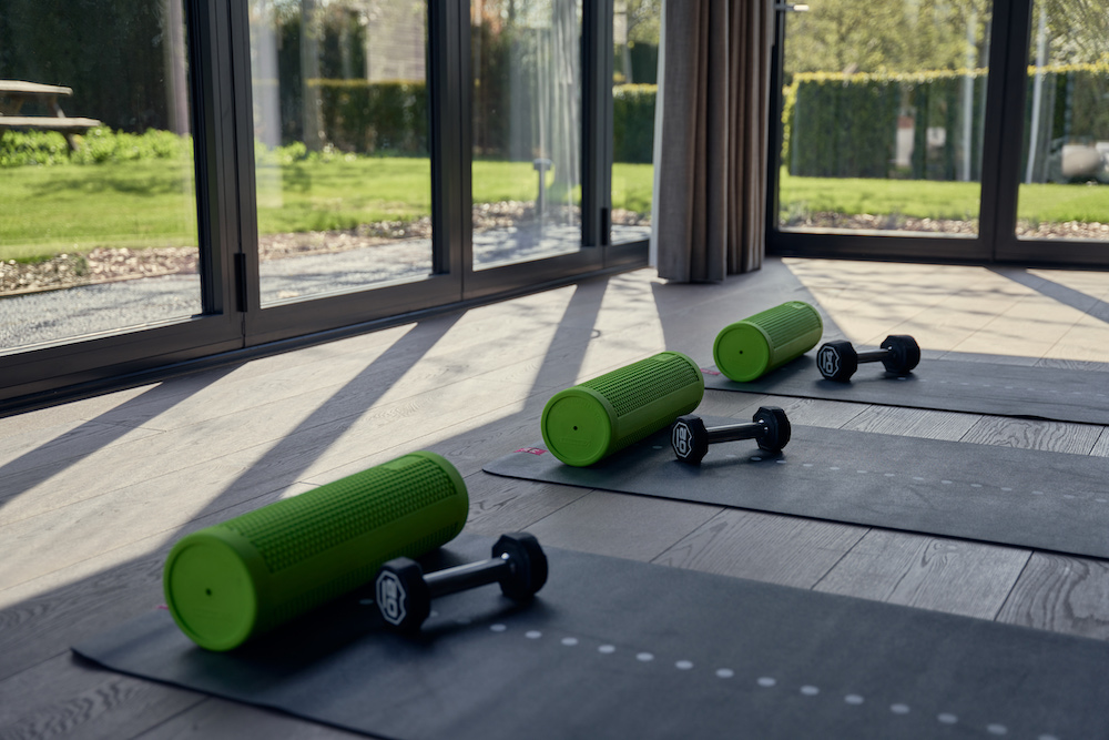 a fitness studio with yoga mats and dumbbells