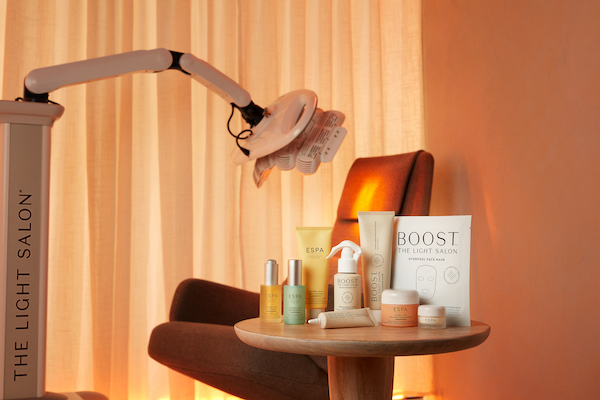 skincare products on a table beside a treatment chair in a spa