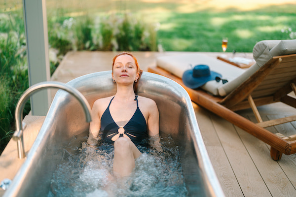 woman relaxing in an outdoor hot tub