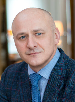 Man in blue suit and tie looking at camera