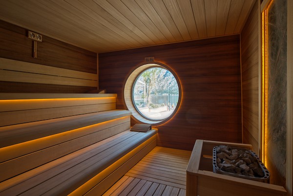 Sauna with round external window looking across the bay