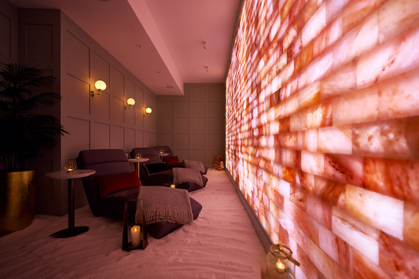 Salt therapy room with relaxation loungers and himalayan salt wall