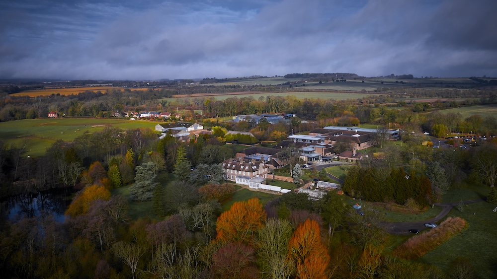 An aerial view of a stately home in autumn