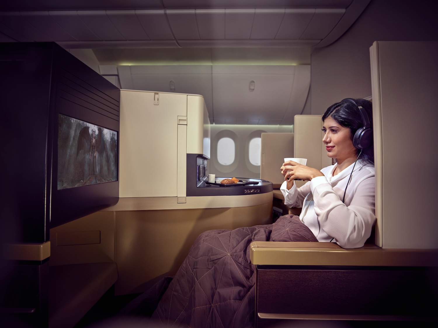 Woman in business class seat on aeroplane