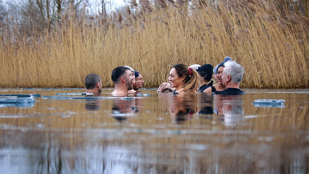 group of people swimming in a lake