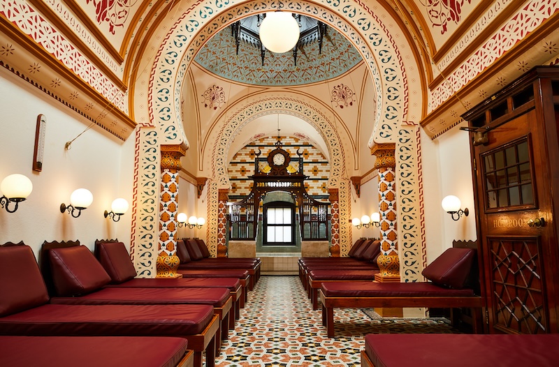 A traditional Turkish bath with loungers in the foreground