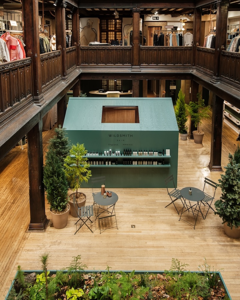A turquoise shed surrounded by living greenery in Liberty department store