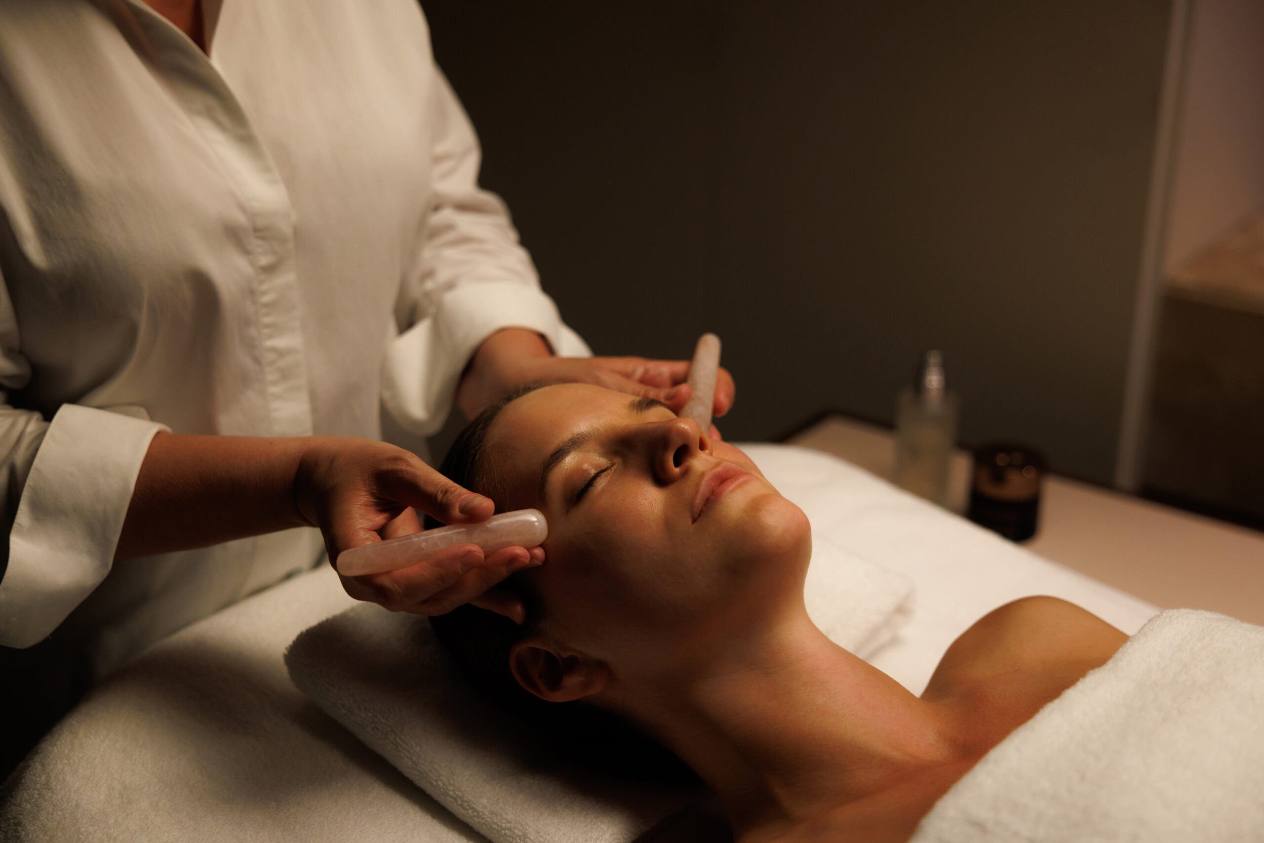 A woman in a spa treatment room having an Omorovicza Golden Experience signature ritual