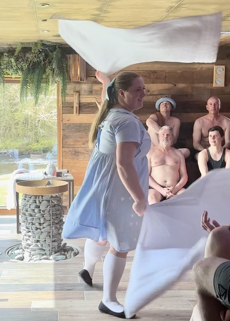 Woman performing sauna ritual with towel