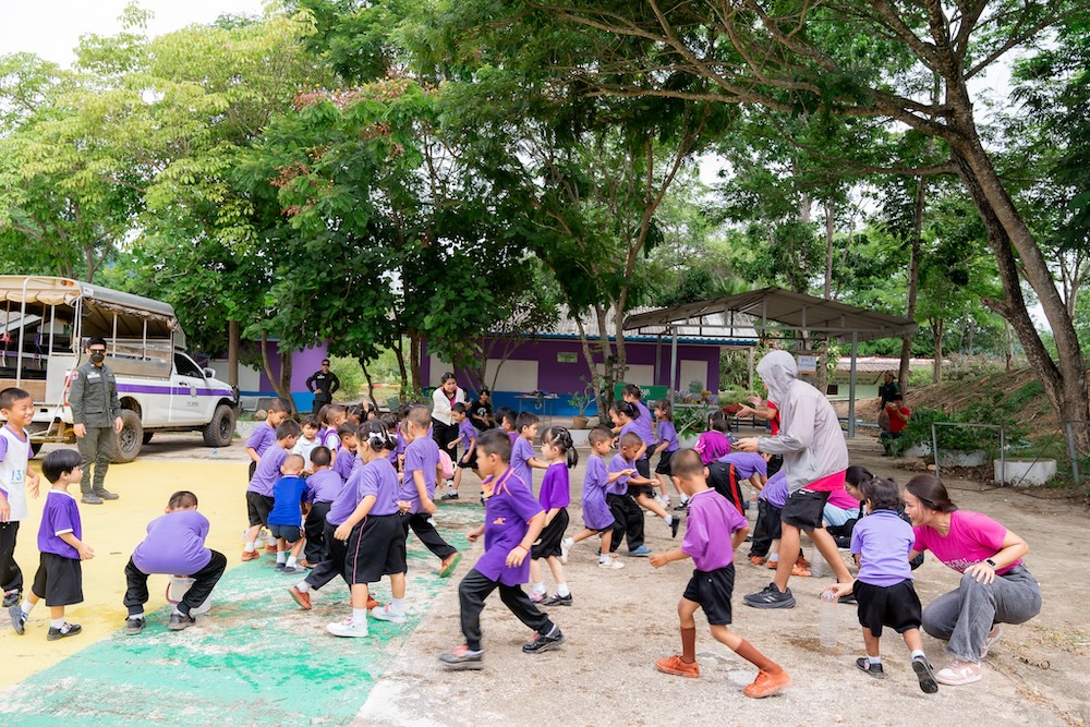 Children in purple tshirts playing a game outside