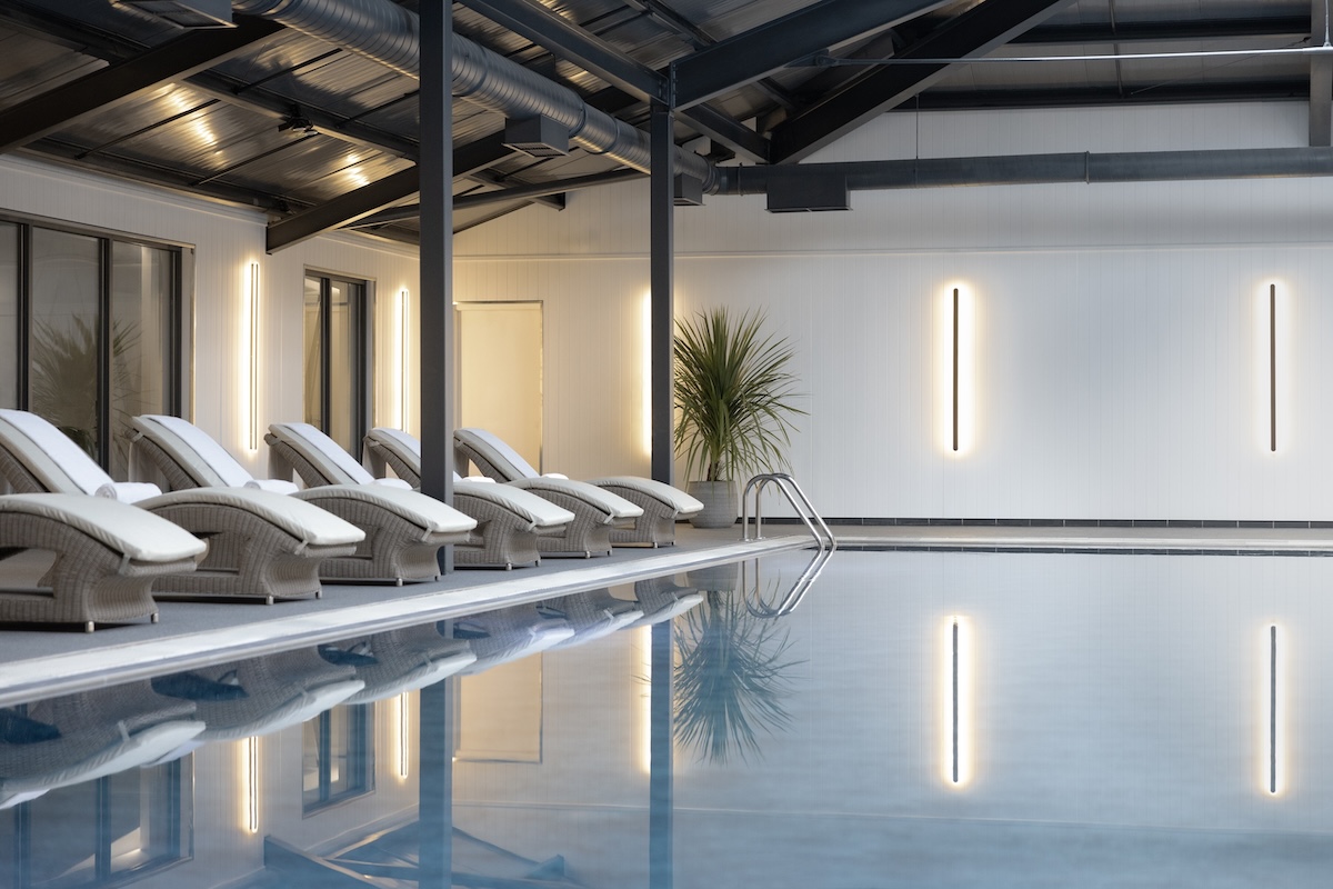 A swimming pool with loungers round the edge