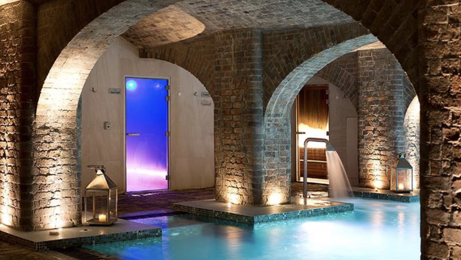 An indoor swimming pool under and arched ceiling