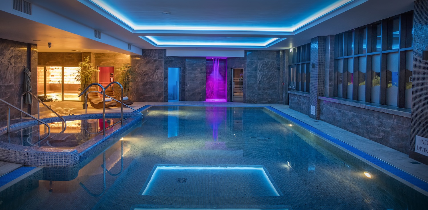 A blue-lit swimming pool