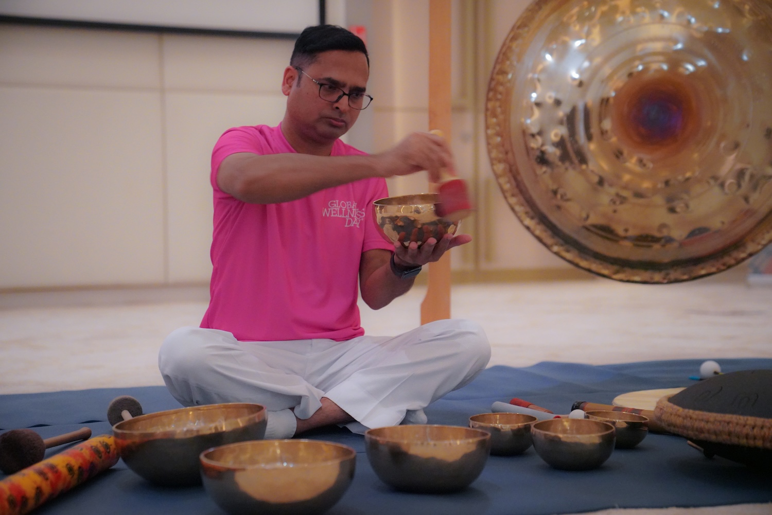 Man in pink tshirt with singing bowls