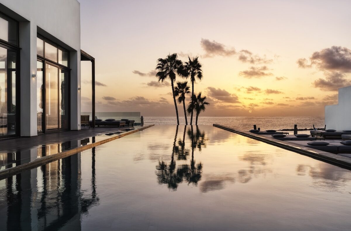 View over a pool and the ocean at sunset