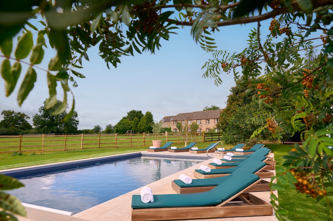 Outdoor pool with loungers on a sunny day