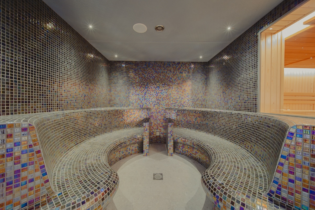 A mosaic tiled steam room in a spa