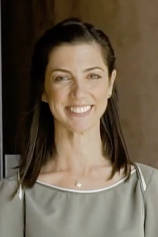 Dark haired woman smiling at camera