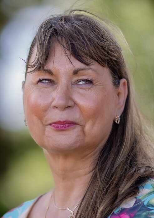 Close up head shot of woman in floral dress