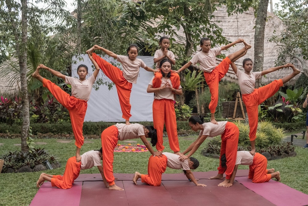 tower of women balanced on each other