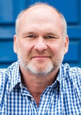 close up head shot of man in checked shirt