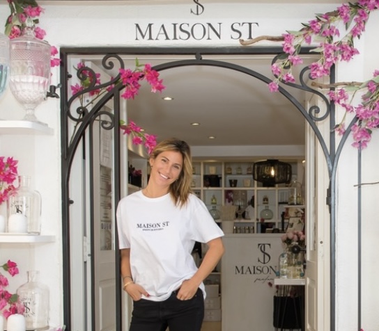 Woman stood in doorway surrounded by flowers