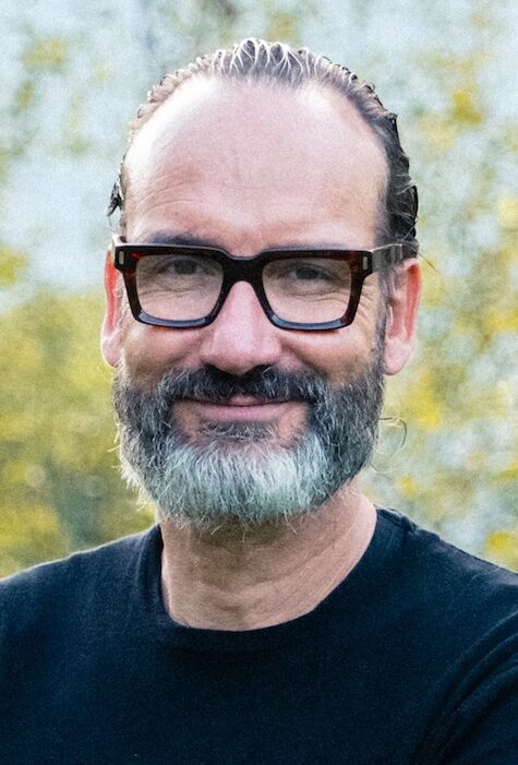 Man with beard and glasses smiling