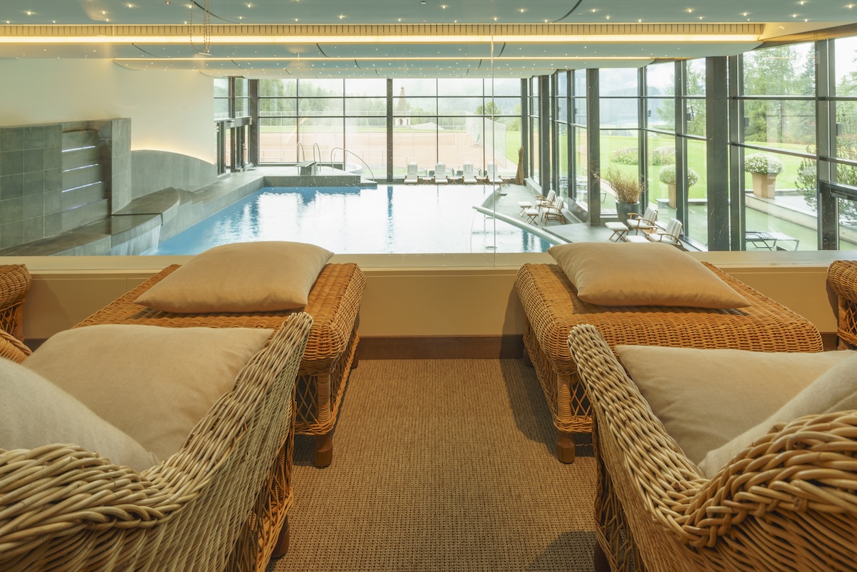 Relaxation beds overlooking a spa swimming pool