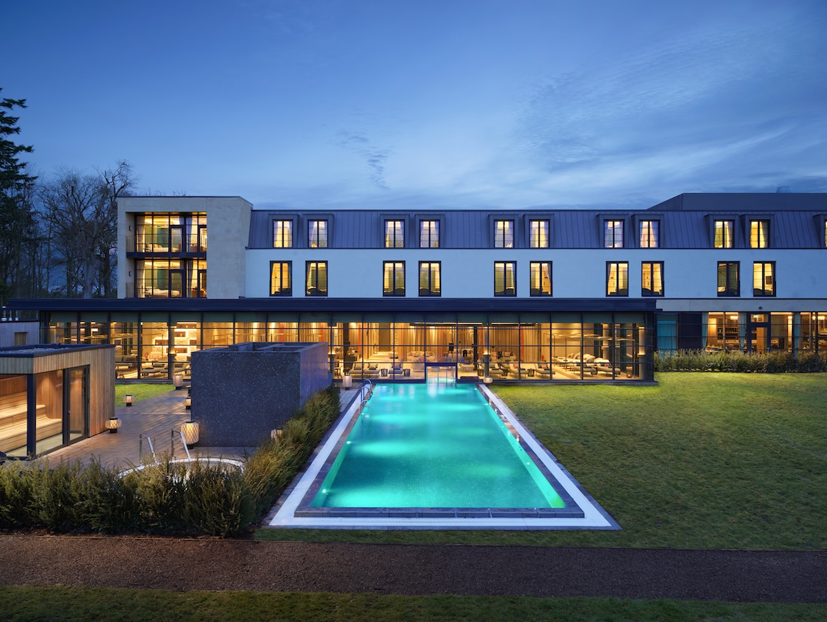 An outdoor pool overlooking a grand old hotel building