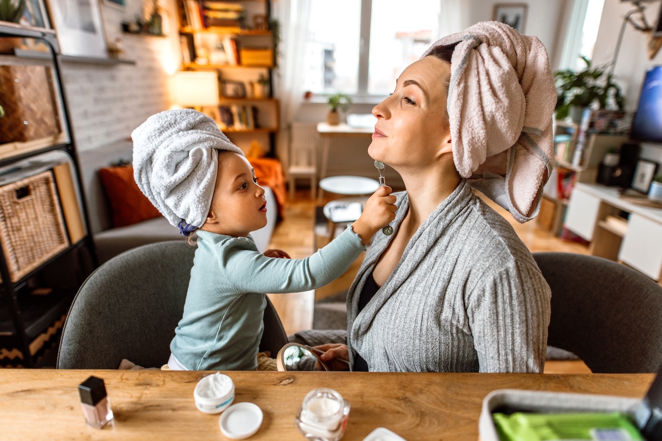 Happy mother and daughter enjoying beauty routine together