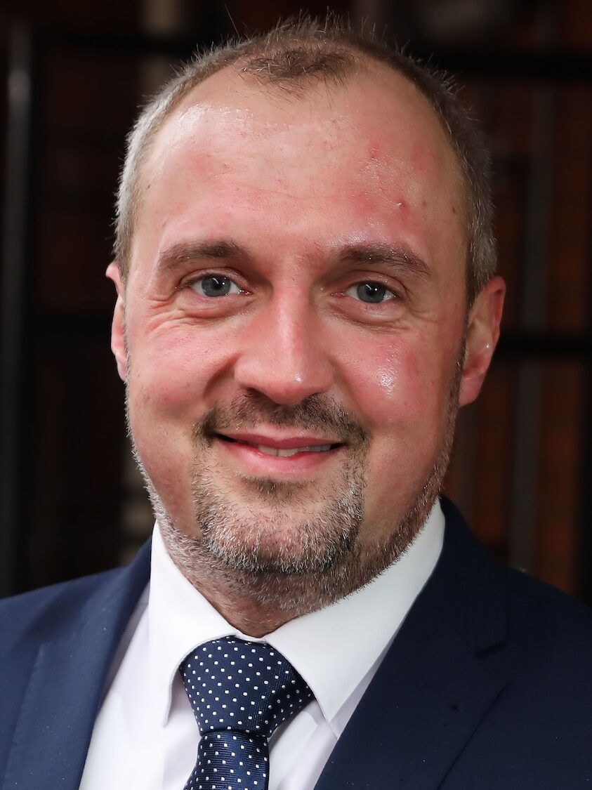 Smiling man in a grey suit