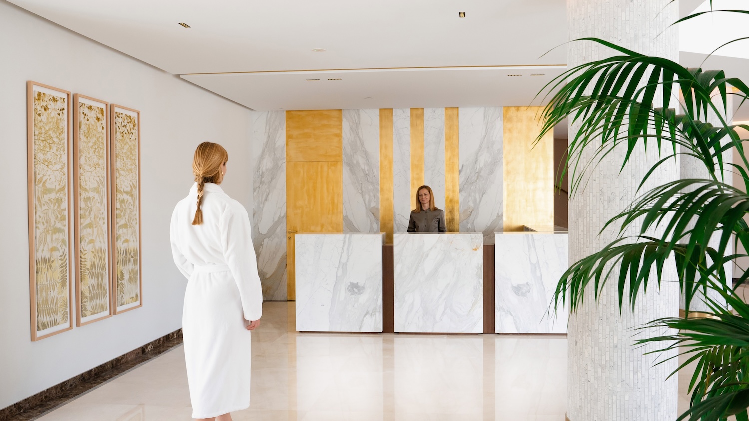 Woman approaching a spa reception desk