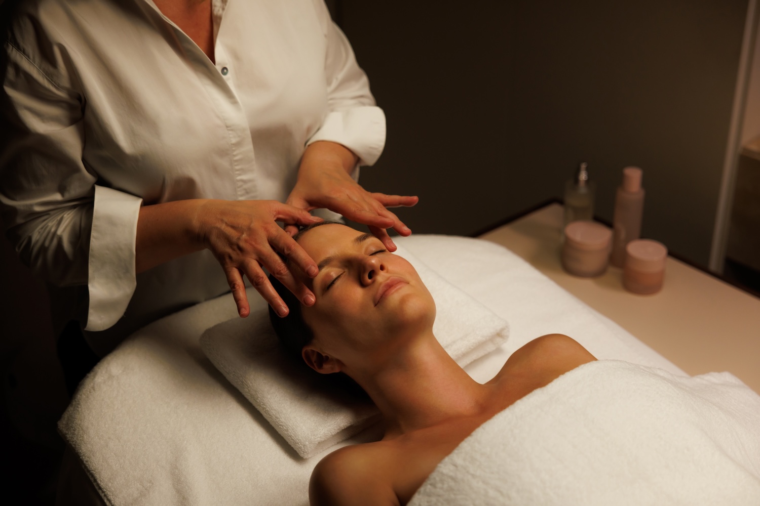 One woman performing facial treatment on another woman