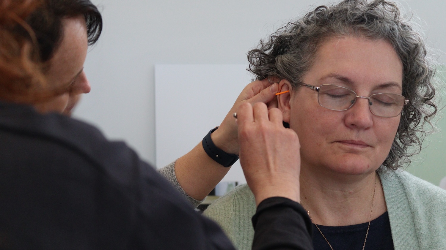 A woman receiving ear acupuncture