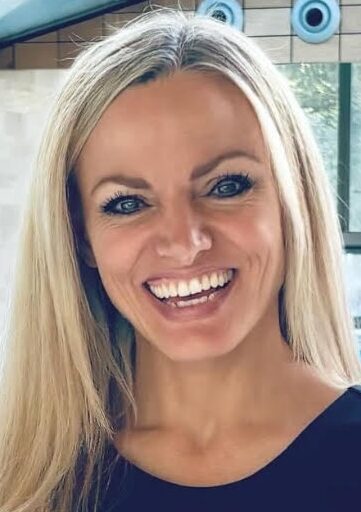 Blonde smiling woman in blue shirt