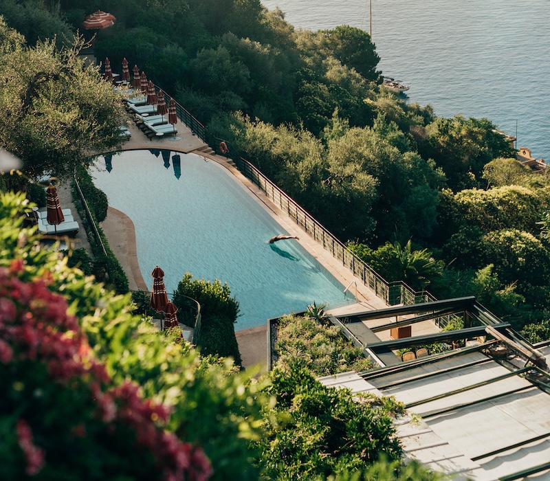 Aerial shot of a hotel swimming pool by the sea