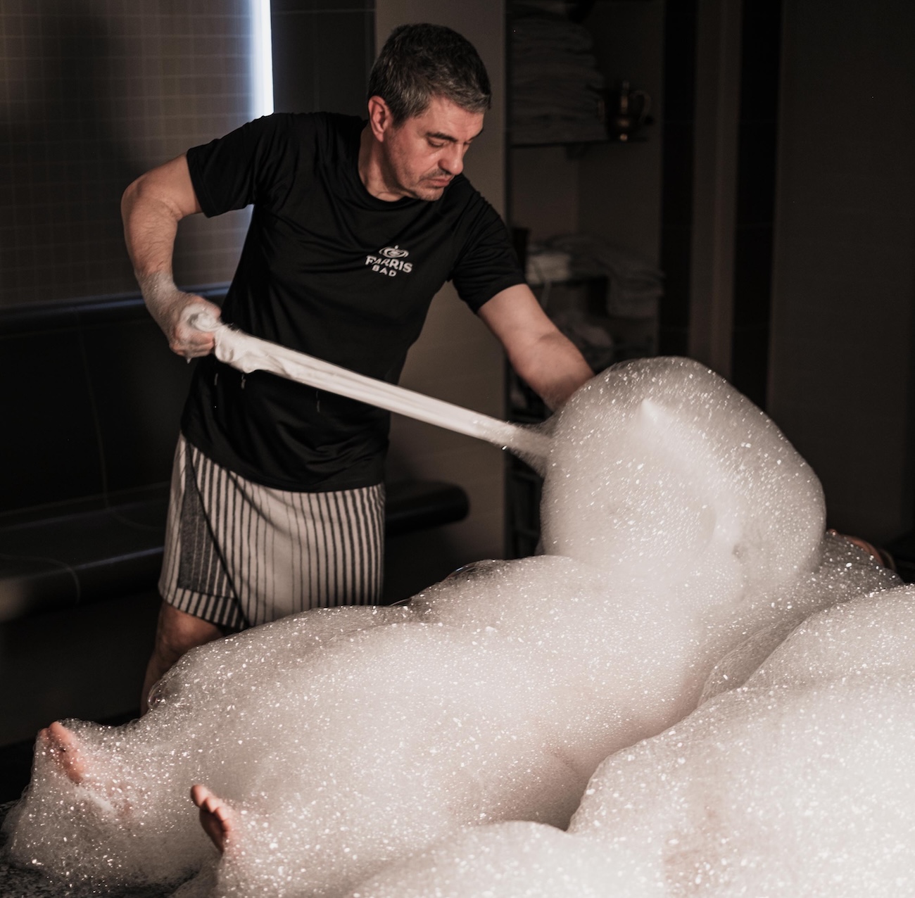 A man providing a hammam treatment