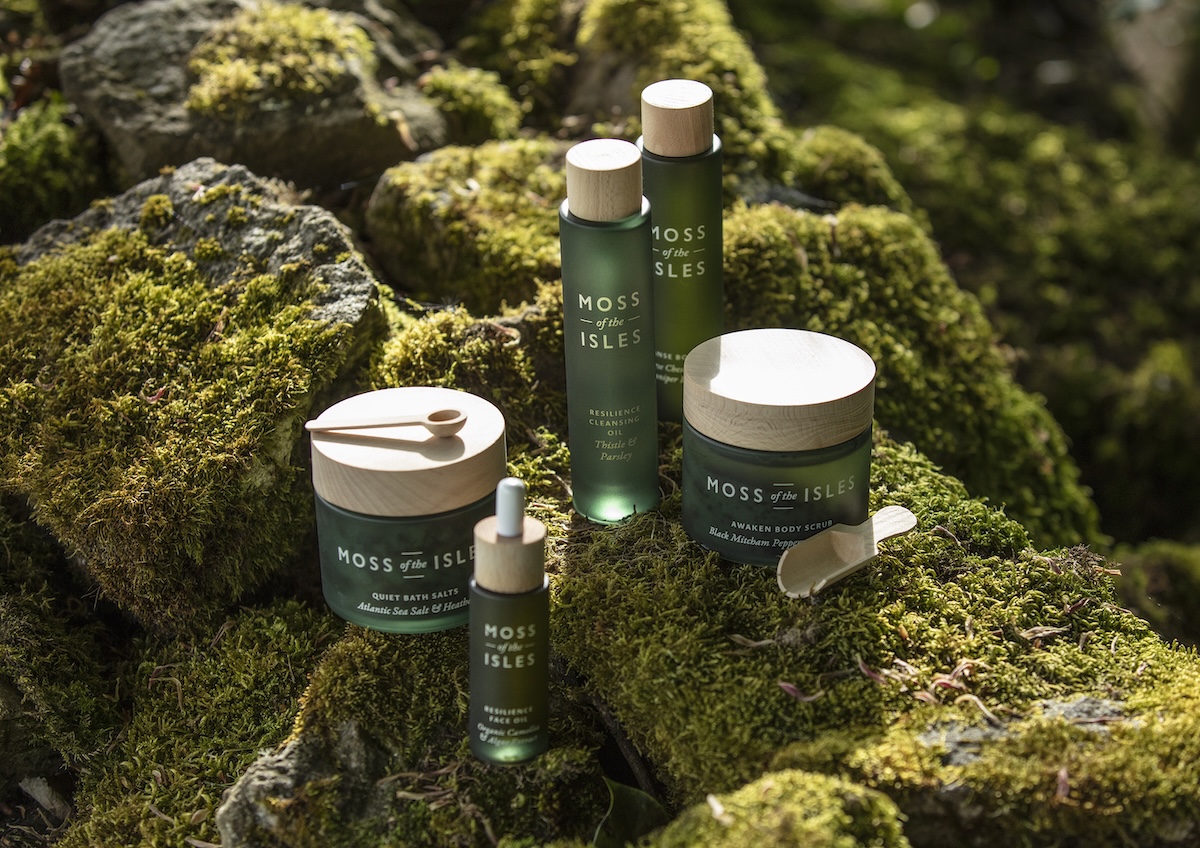 Spa products laid out on moss