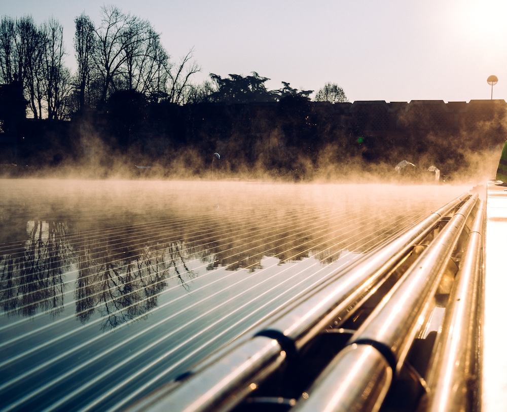 An outdoor thermal pool at sunset