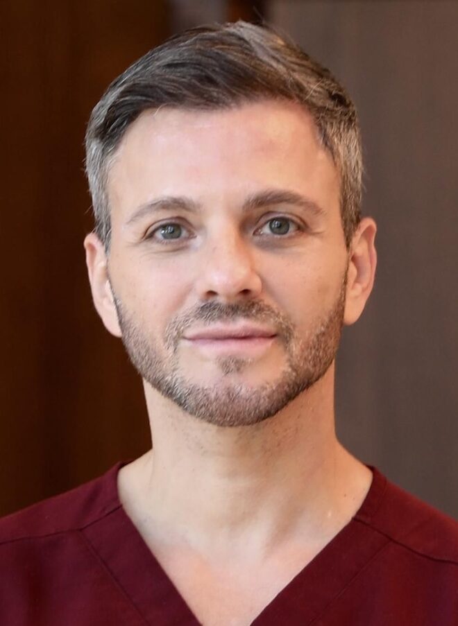 Man wearing burgundy scrubs