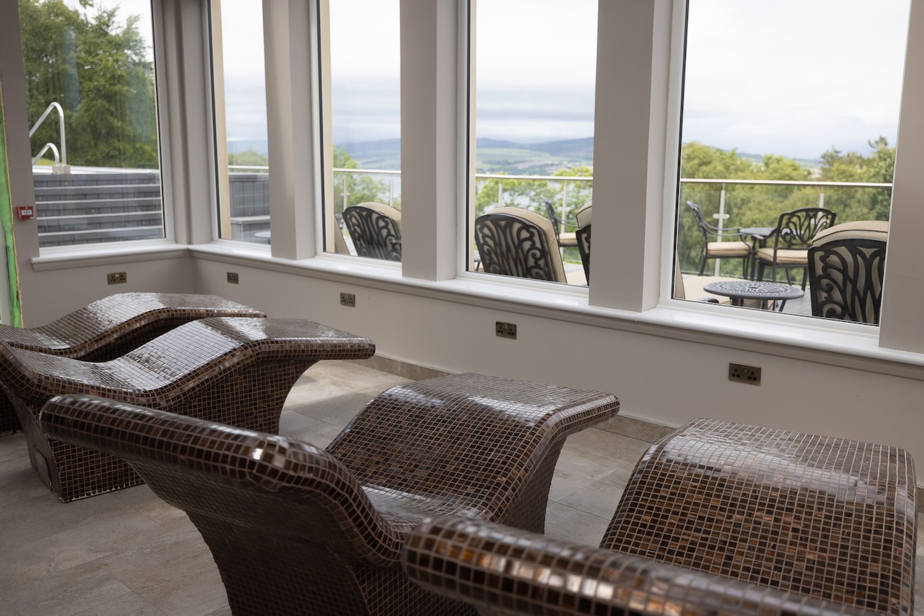 Relaxation beds overlooking a view of the Scottish highlands