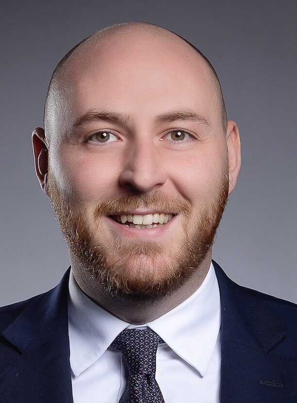 Bald smiling man with beard in suit and tie