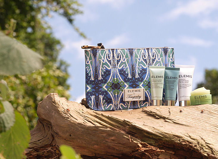 Elemis products style don a rock next to a Temperley London bag