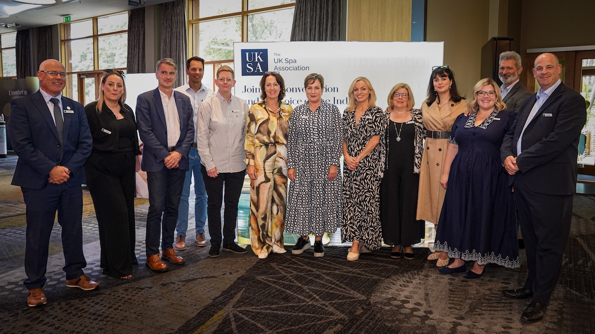 A group of people posing for the camera at a business event